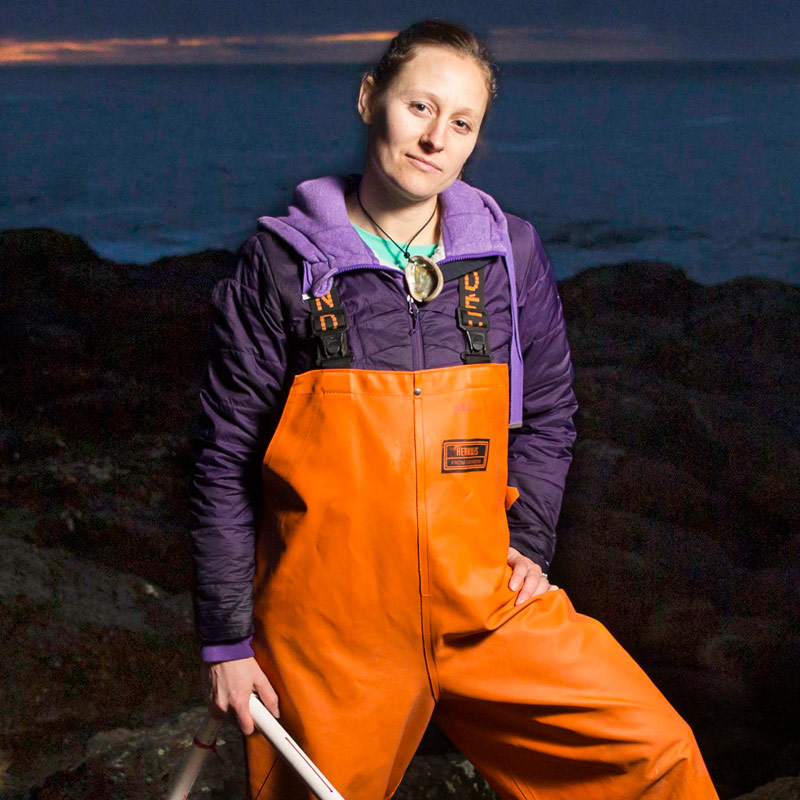 Doctor Sarah Gravem posing on a beach at night